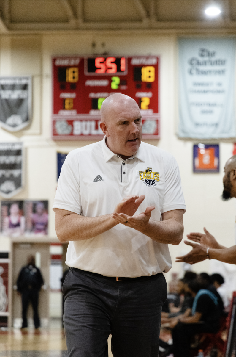 Coach applauds team's successful effort to even the score to 18-18 at Butler. 